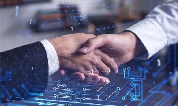 Business partners shaking hands over a deal.