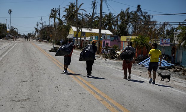 Residents evacuate following Hurricane Ian in Matlacha Isles, Florida, US, on Saturday, Oct. 1, 2022. Research firm Enki Holdings LLC pegs the economic cost of Hurricane Ian at $60 billion to $70 billion, based on damage to homes and infrastructure, as well as the cost of reconstruction and longer-term knock-on effects including the disruption in tourism. (Credit: Eva Marie Uzcategui/Bloomberg)