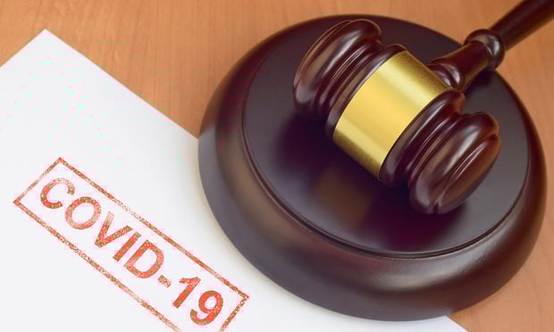 A gavel lies on a desk next to a paper with 
