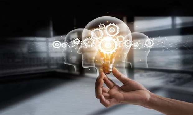 A hand holding a light bulb to illustrate innovation.