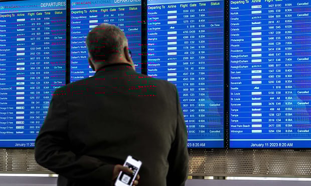 Cancelled and delayed flights on a departure board at Ronald Reagan National Airport (DCA) in Arlington, Virginia, on Wednesday, Jan. 11, 2023. U.S. aviation authorities halted flights nationwide early Wednesday after the failure of a key pilot notification system operated by the Federal Aviation Administration. (Credit: Nathan Howard/Bloomberg) 