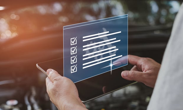 A person holds a digital checklist