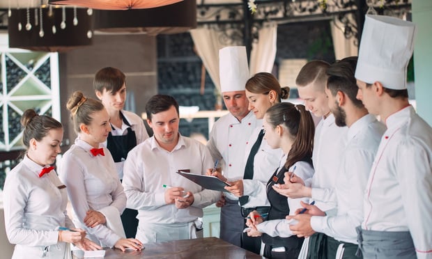 Photo of restaurant staff meeting.