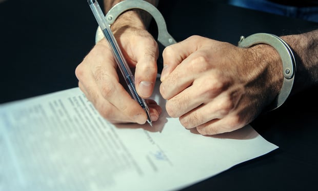 Men's hands in handcuffs. Plea agreement Max Sky/Shutterstock
