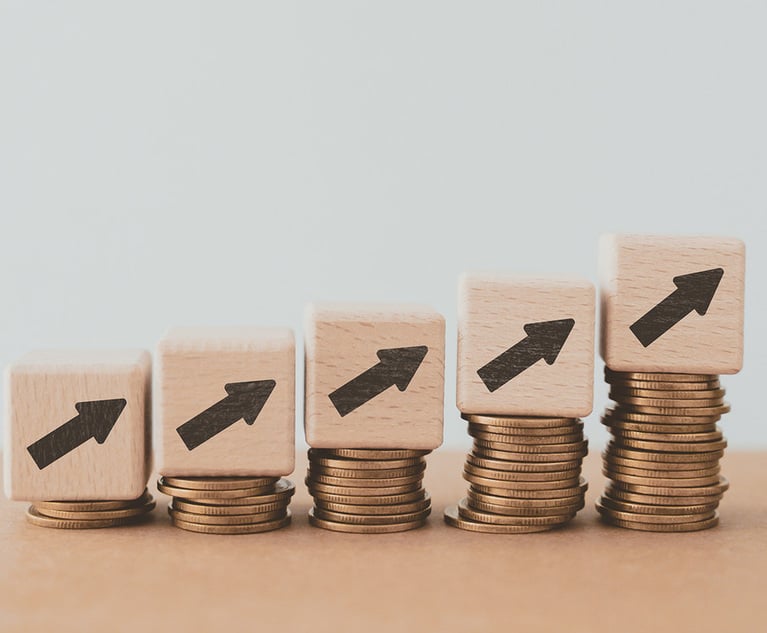 Four blocks with upward-pointing arrows on top of progressively taller stacks of coins.