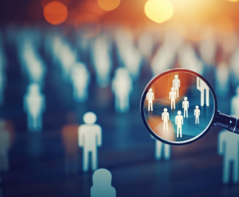 An illustration of a bunch of human figures, with a few highlighted within a magnifying glass.
