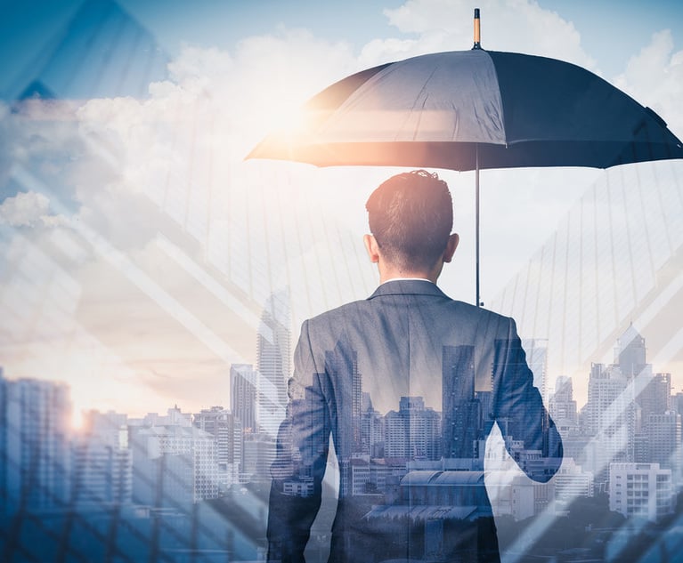 A business man holds and umbrella.