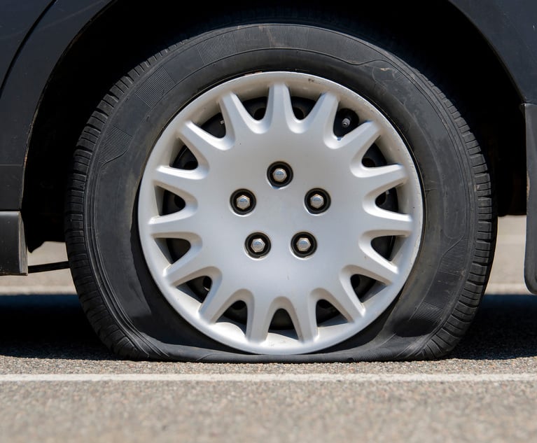 During a routine tire change, a customer assisting with the process was injured when the vehicle fell off a standard jack, presenting a unique commercial coverage question. Credit: madscinbca/Adobe Stock