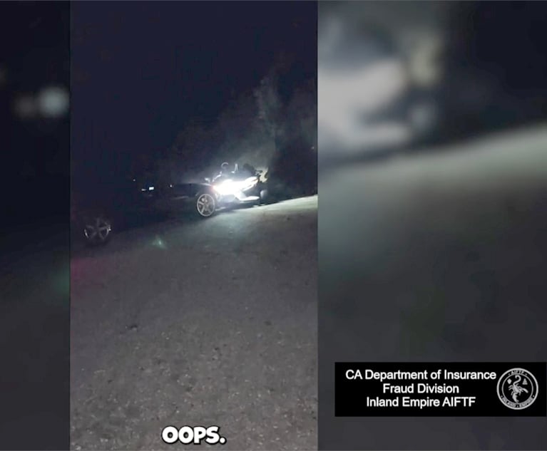 A screenshot from the video of a staged accident involving a BMW sedan and a three-wheel motorcycle. (Credit: California Department of Insurance)