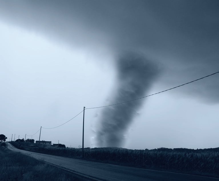 A funnel cloud near a roadway