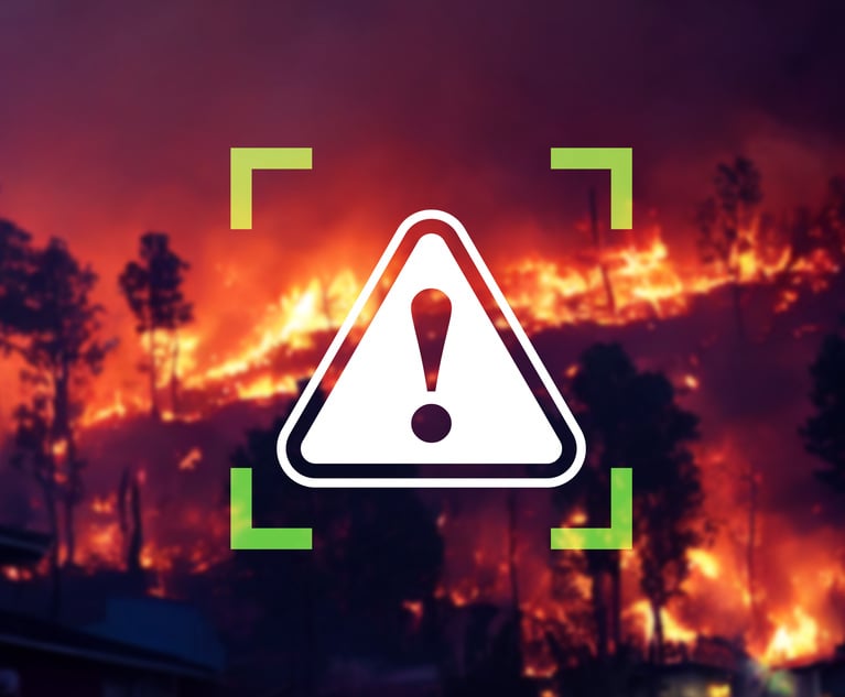 A danger sign overlayed on a photo of a wildfire