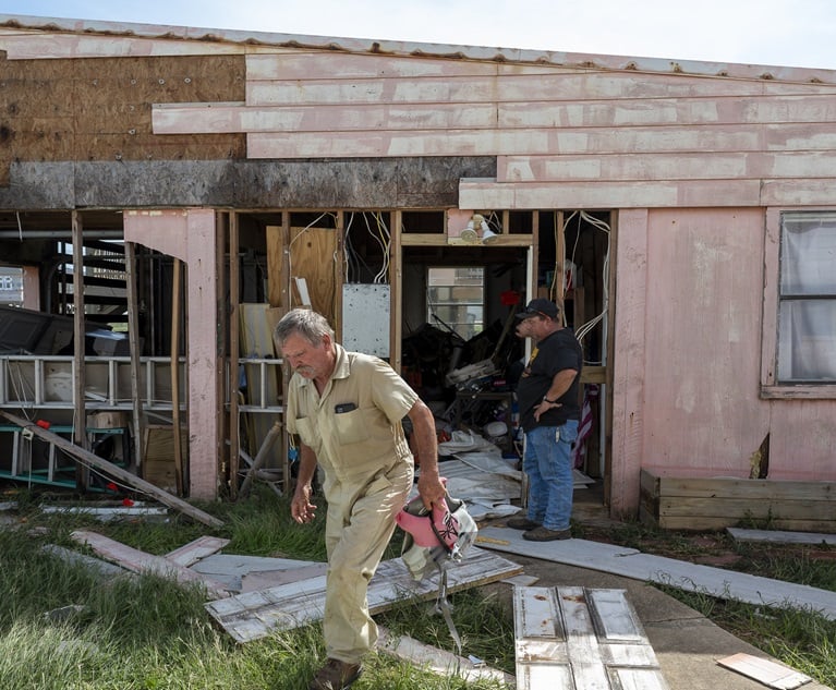 Residents around a damaged house after Hurricane Beryl made landfall in Sargent, Texas on July 8. (Photographer credit: Eddie Seal/Bloomberg)