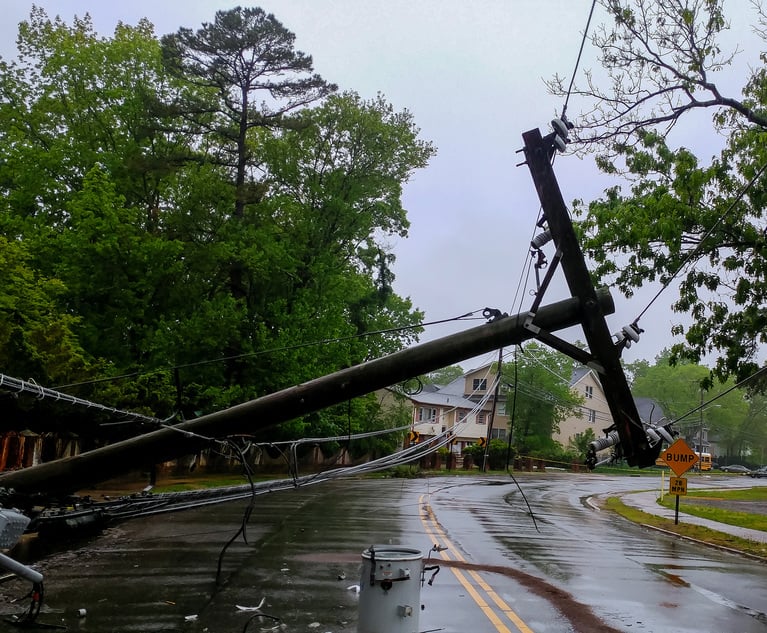 Power lines laying across a road after a storm