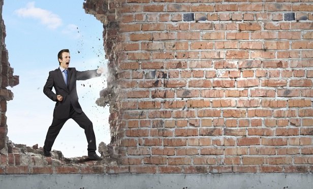A man fighting a wall
