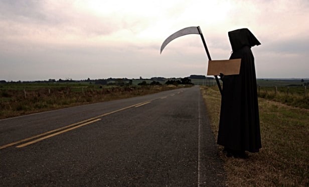 The grim reaper standing by the highway