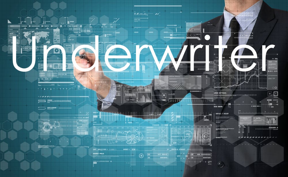 Man's hand writing "Underwriter"