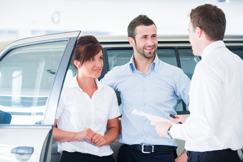 auto insurance agent talking to couple