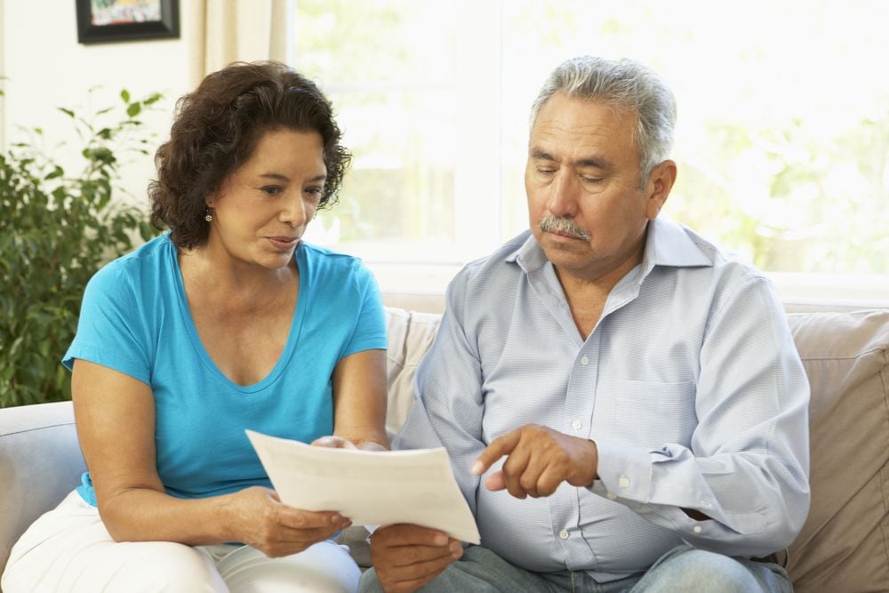 Couple reading homeowners insurance policy