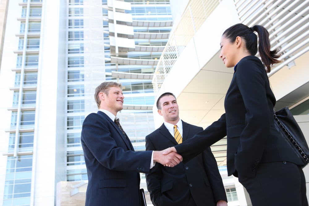 Business men and woman shaking hands