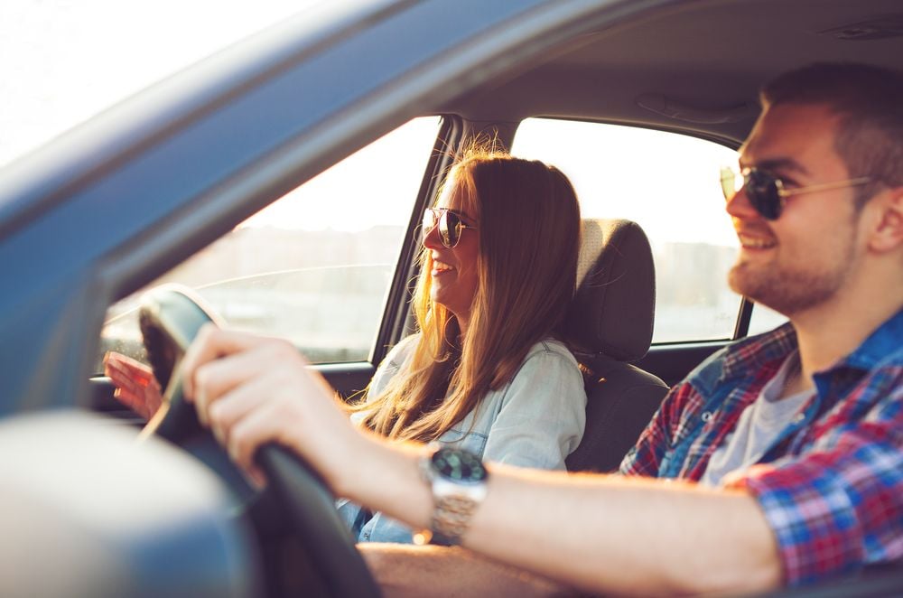 man driving car with woman passenger