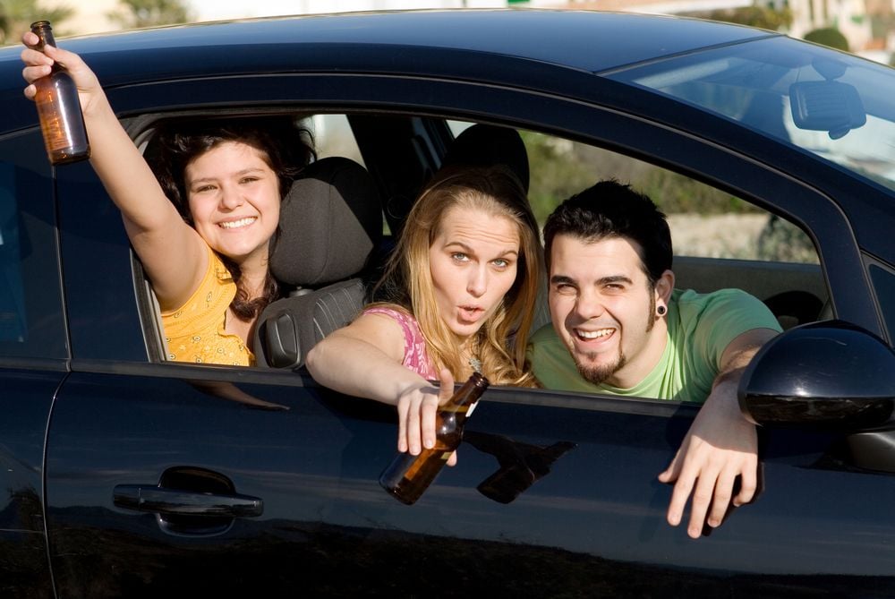 teenagers drinking alcohol in a car