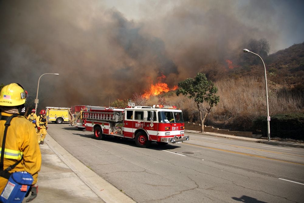 Firefighters and emergency personal rush to control fires in Brea, California