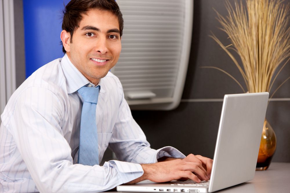 businessman typing on laptop