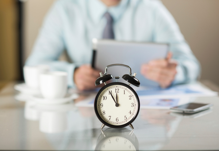 alarm clock on man's desk