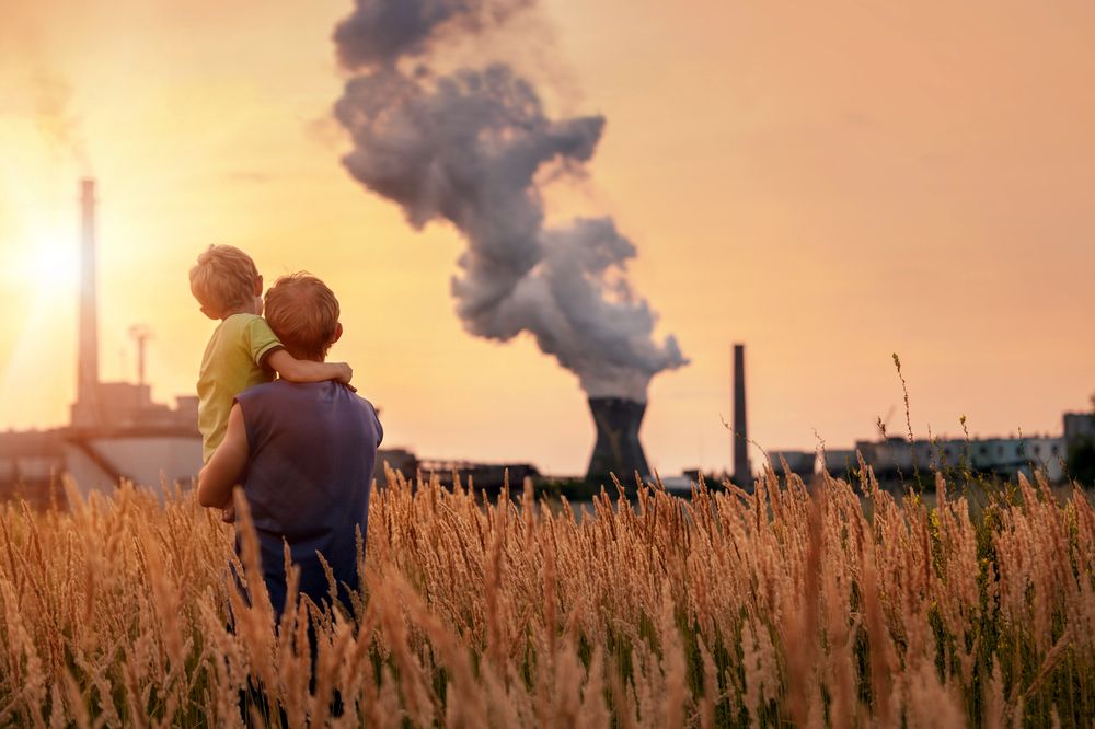 father and young son looking at chemical plant