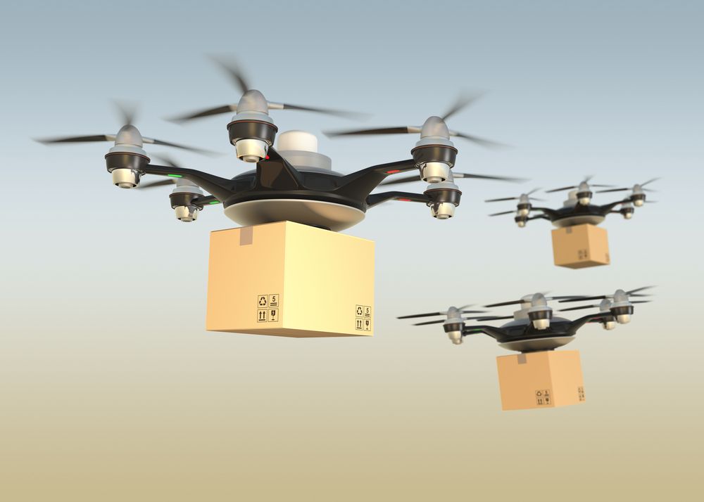 multiple drones carrying cardboard boxes