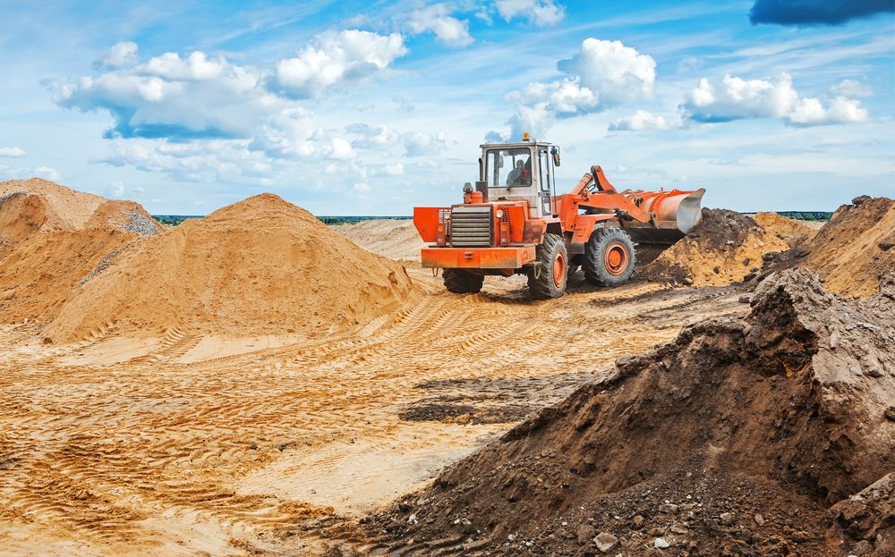 construction equipment scooping sand