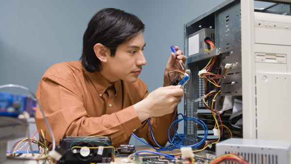 computer repairman working on hard drive