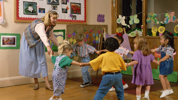 teacher playing with young children