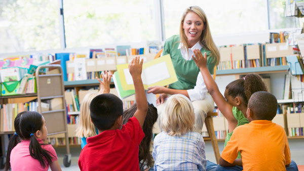 teacher reading to young kids