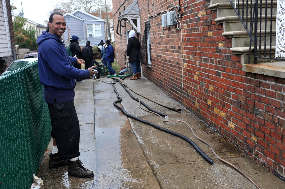 People-pumping-out-flooded-basement-SS-FashionStock.com 