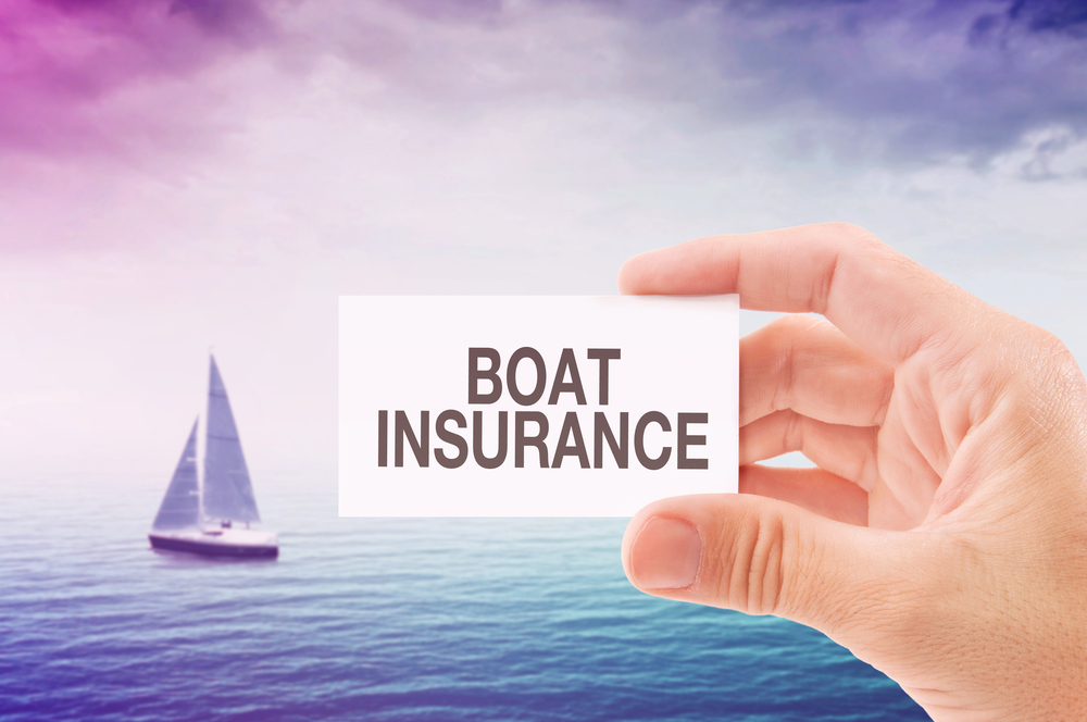 Boat-insurance-on-business-card-man's-hand-boat-in-water-background-shutterstock_260681252-igor.stevanovic