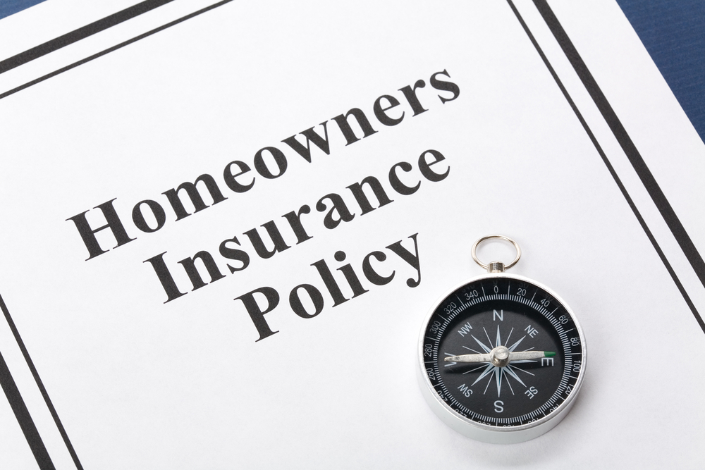 Homeowners-insurance-policy-document-with-compass-shutterstock_17551162-Feng Yu