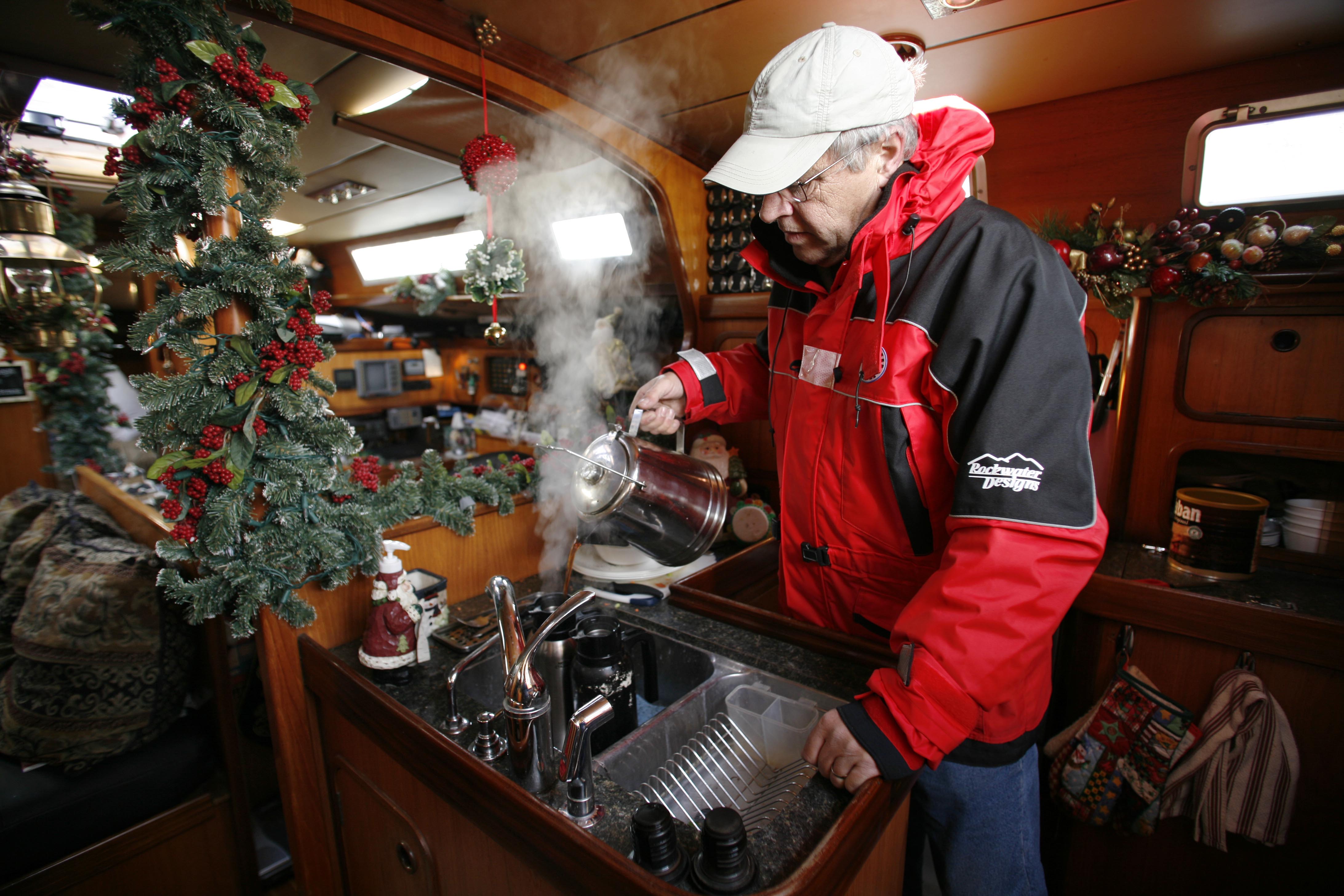 Ken-Fine-pours-hot-coffee-in-galley-of-live-aboard boat-AP_061215029226-John Froschauer