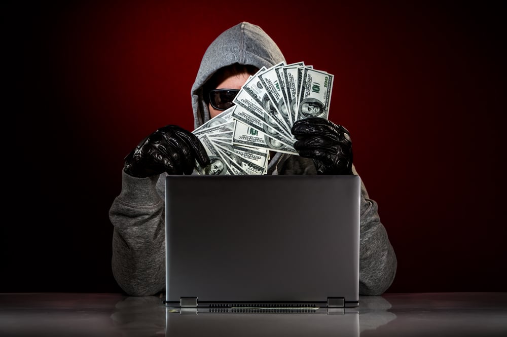 Young-hacker-in-hoodie-&-sunglasses-with-money-shutterstock_139949650-Andrey Armyagov