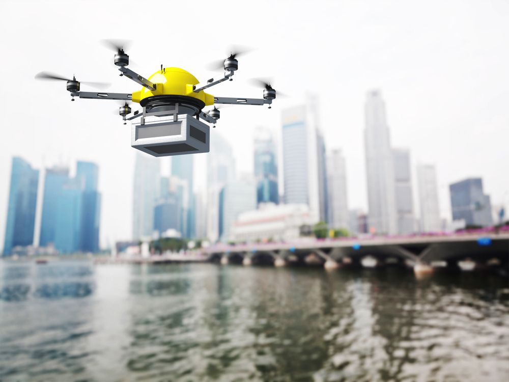 drone flying over water and city