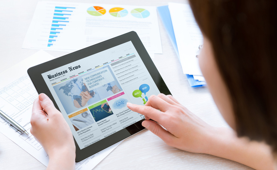 Young-business-woman-reading-news-on-tablet-crop-shutterstock_141377746-Bloomua