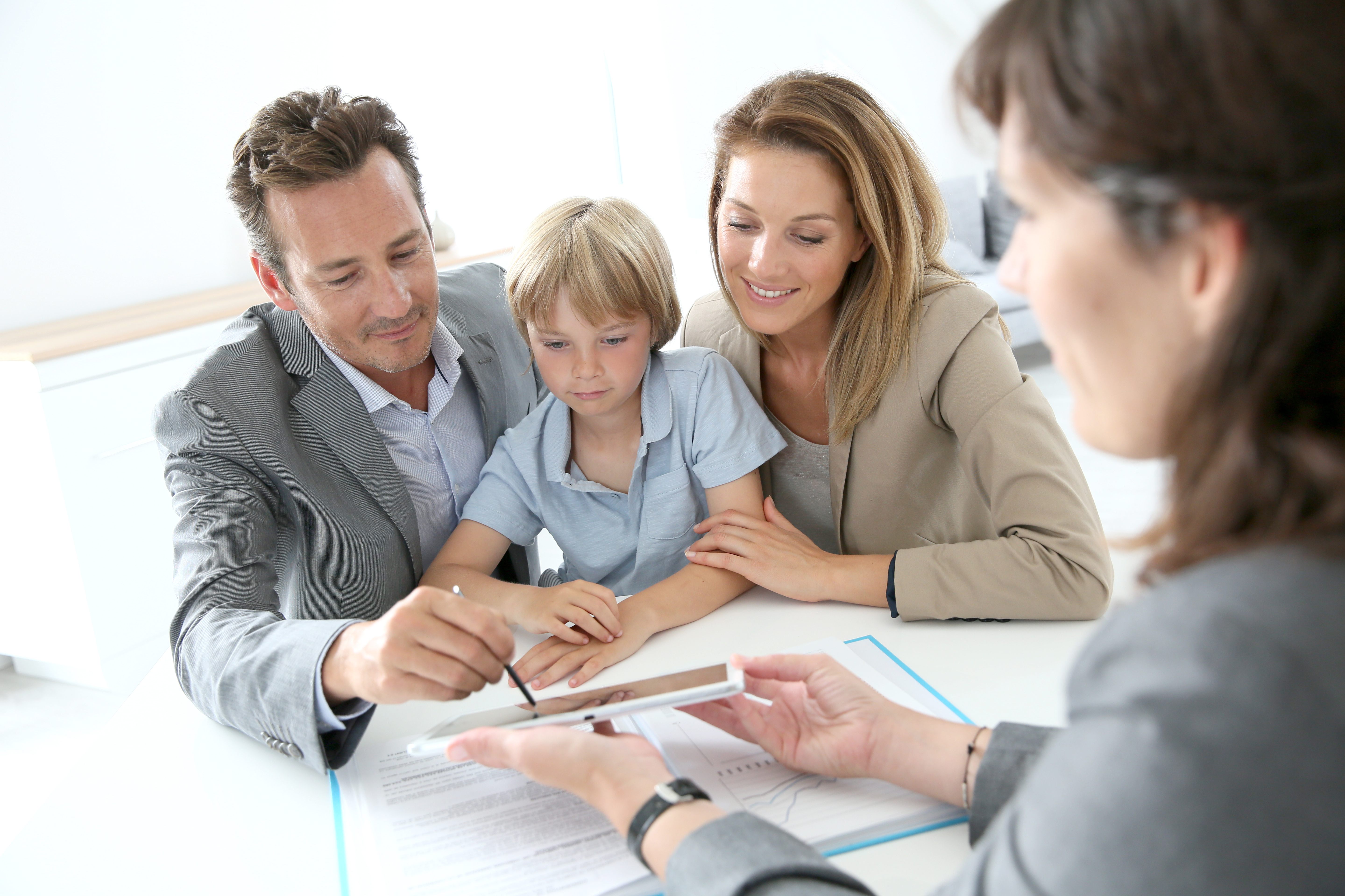 man with his family signing signature on a tablet