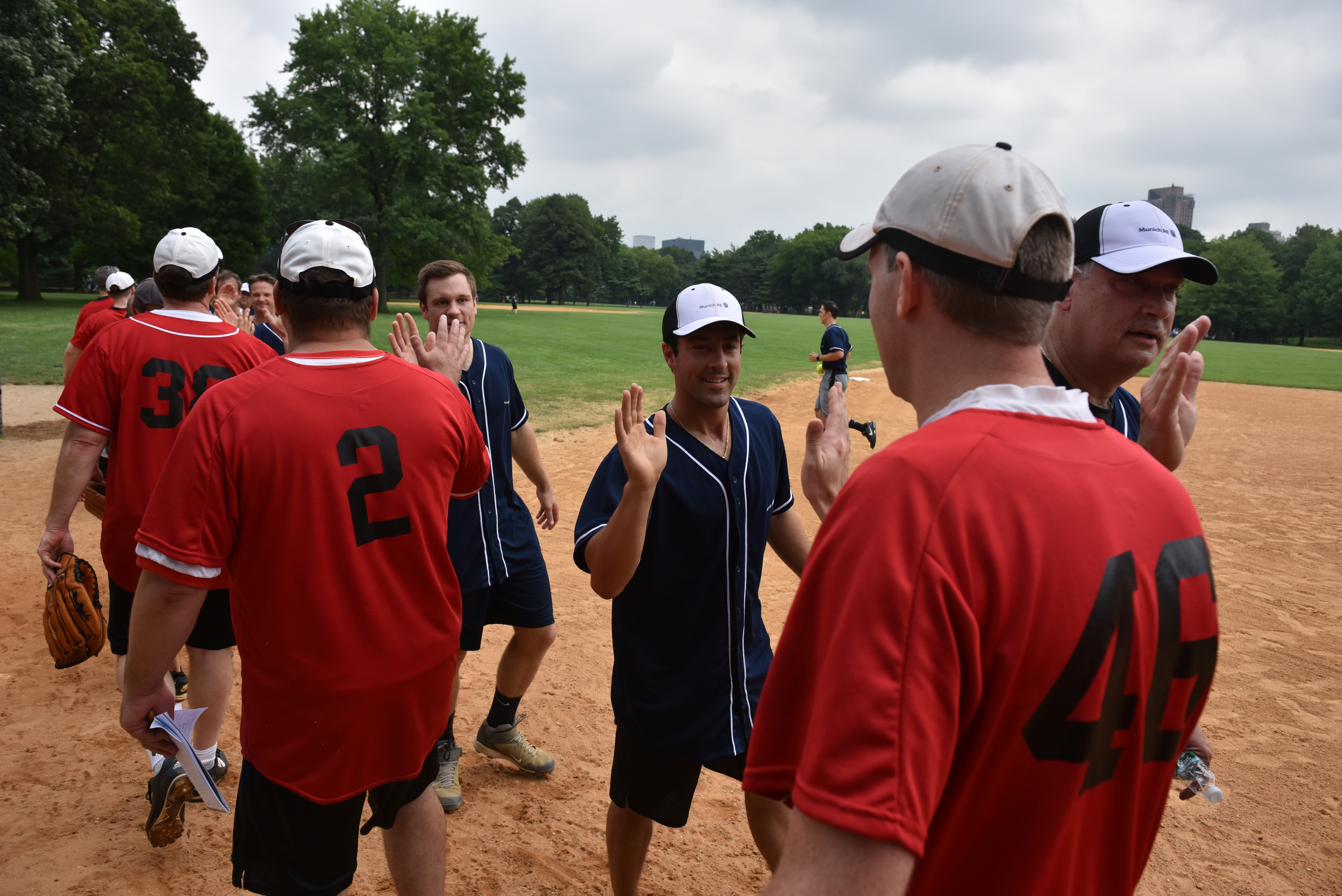 2-softball-teams-greeting-end-of-game-MunichRe-contributed-photo