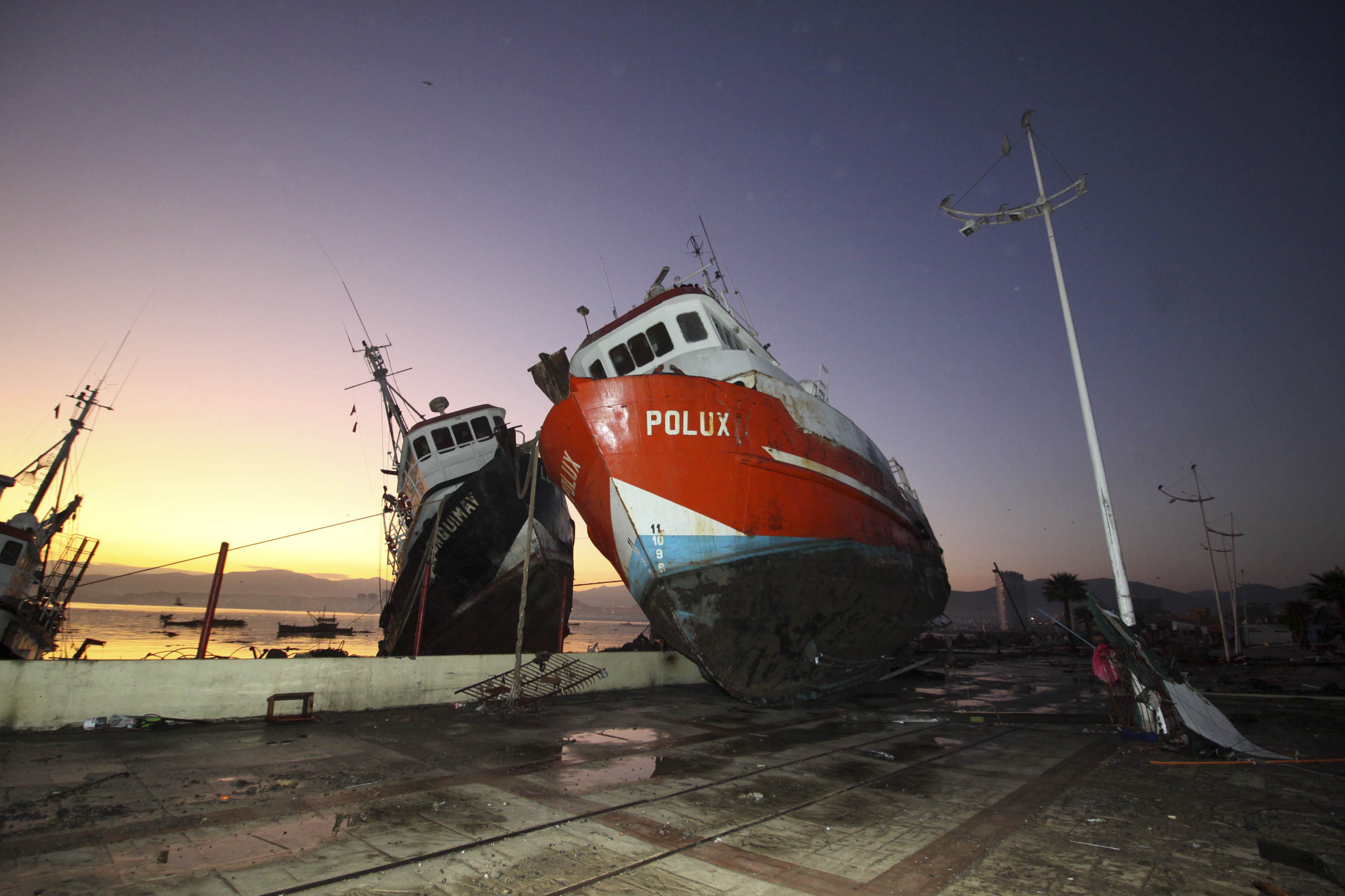 A boat stands on a dock after it was lifted by an earthquake-triggered tsunami in Coquimbo, Chile, Thursday, Sept. 17, 2015.