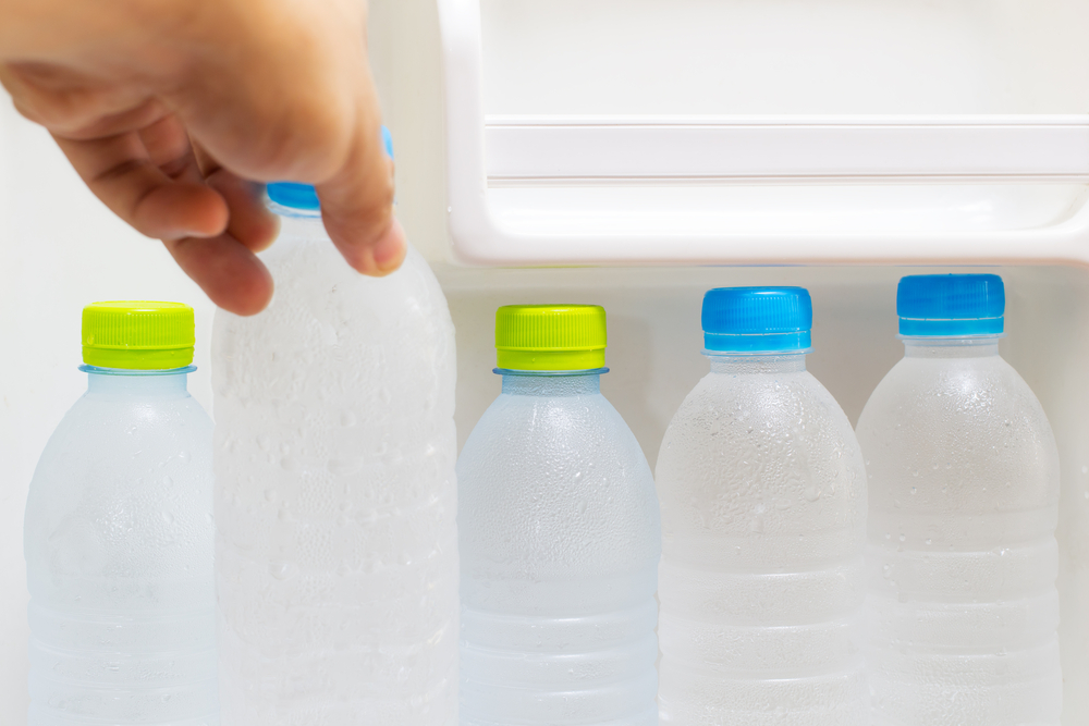 Hand-taking-water-bottles-out-of-fridge-SS-PrinceOfLove