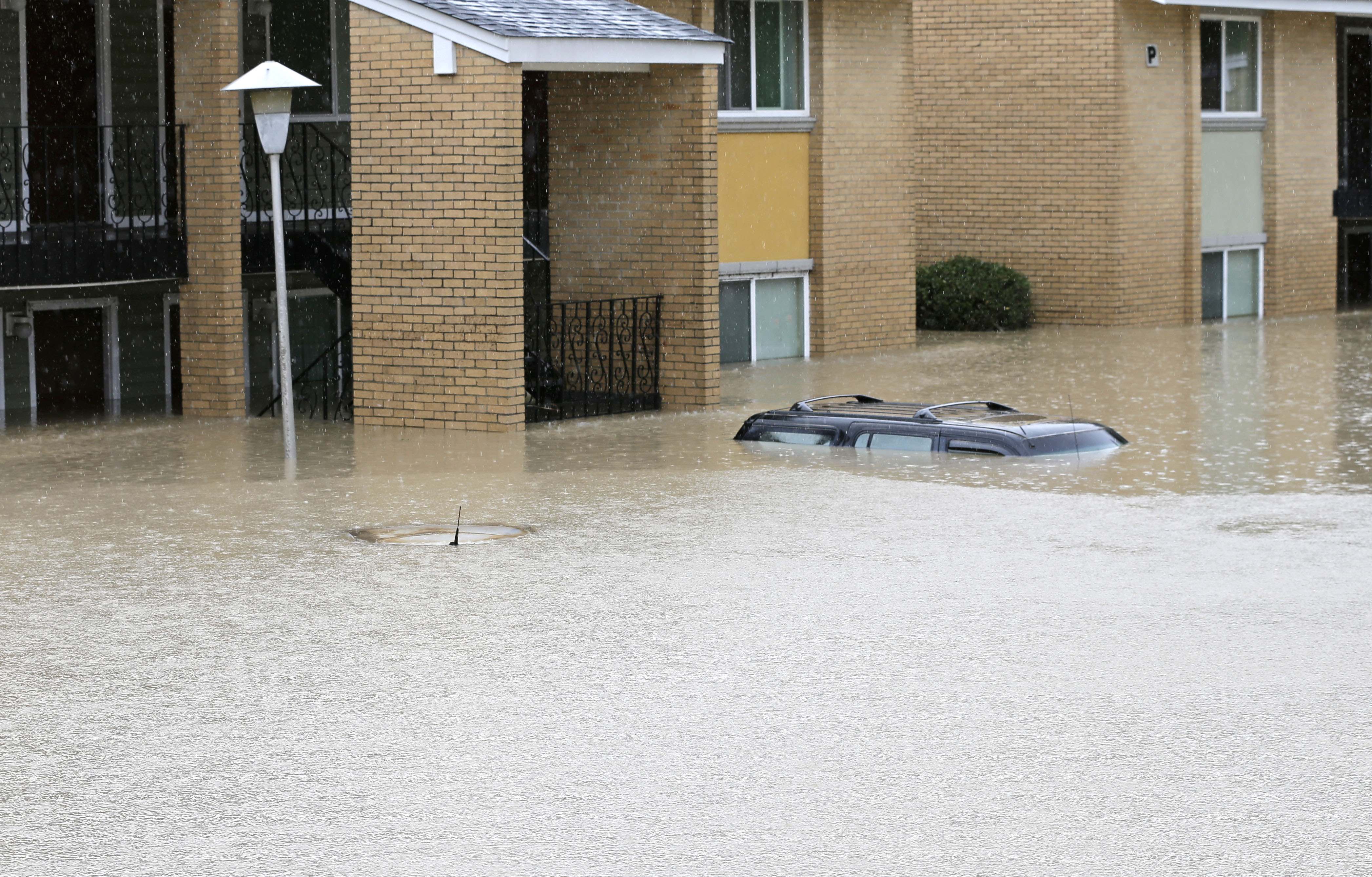 Flood waters engulf cars at an apartment complex in Columbia, S.C., Sunday, Oct. 4, 2015.