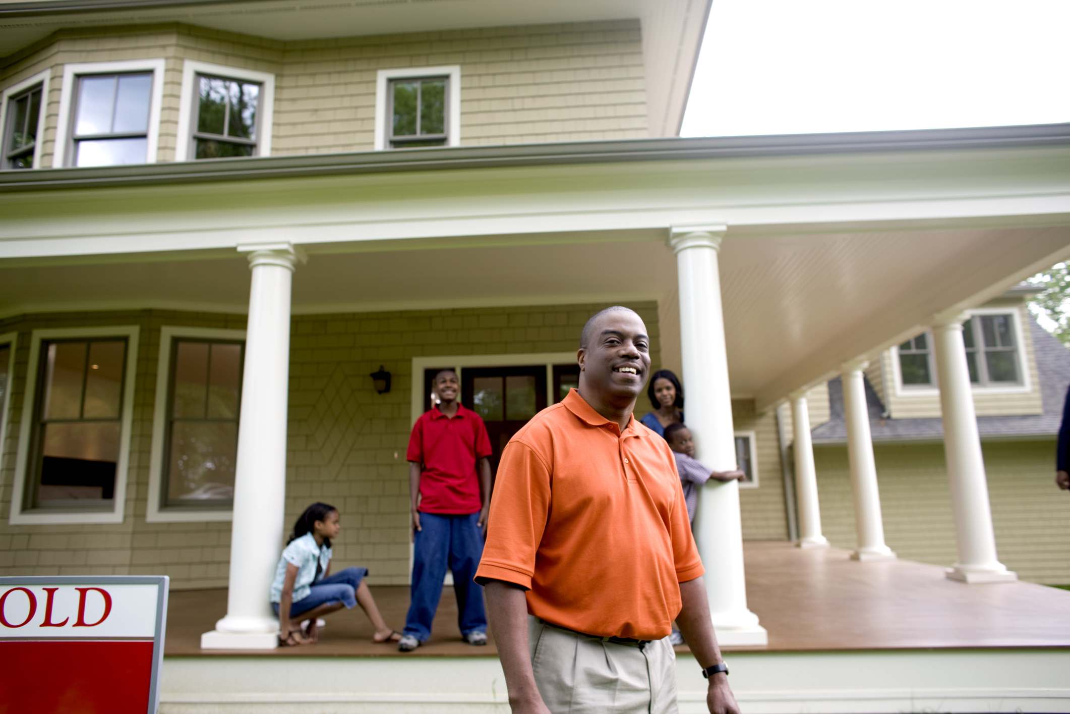 family outside their new house