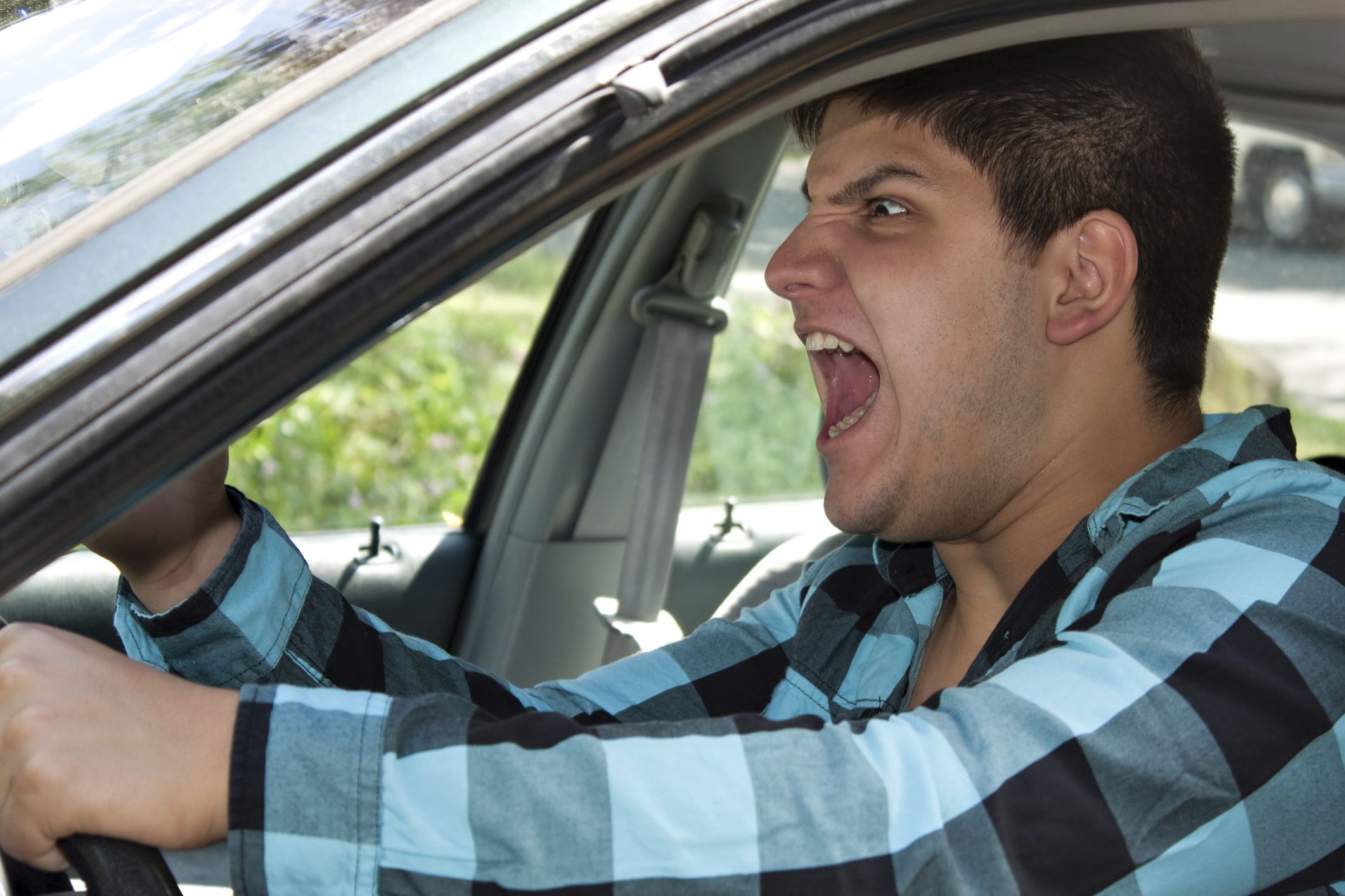 angry man behind the wheel of a car