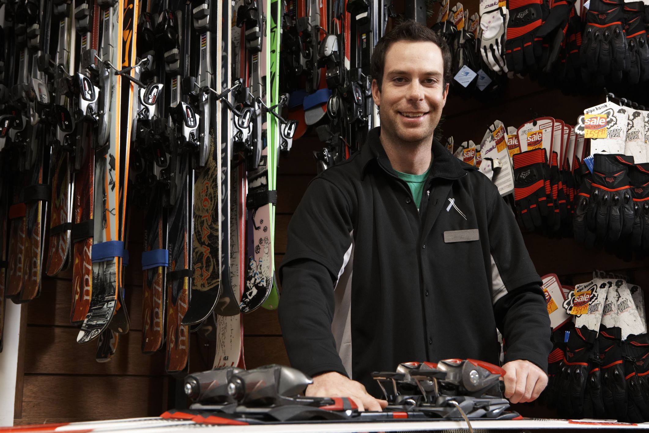 Man checking skis and bindings in a shop