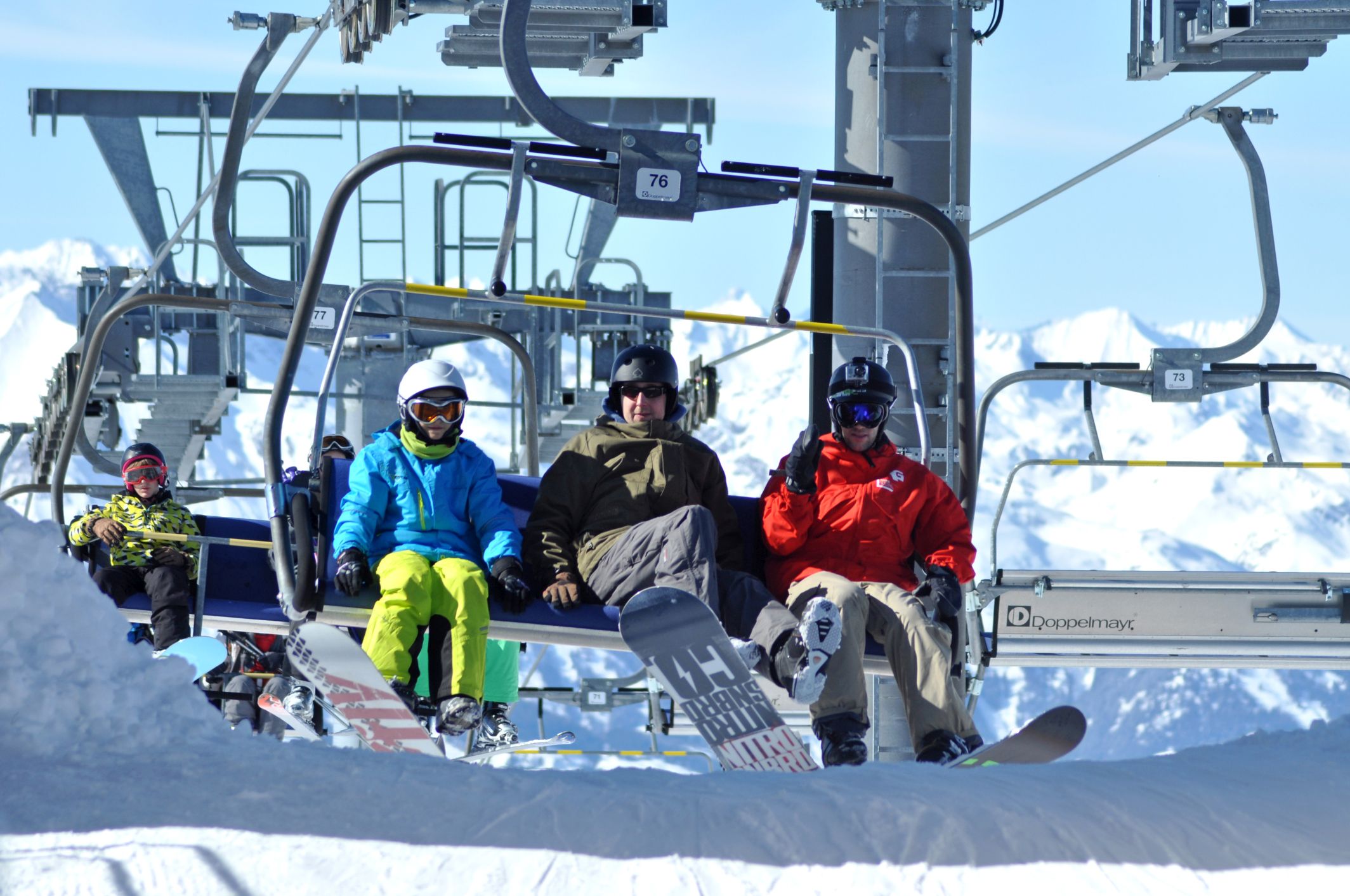 snowboarders on a ski lift